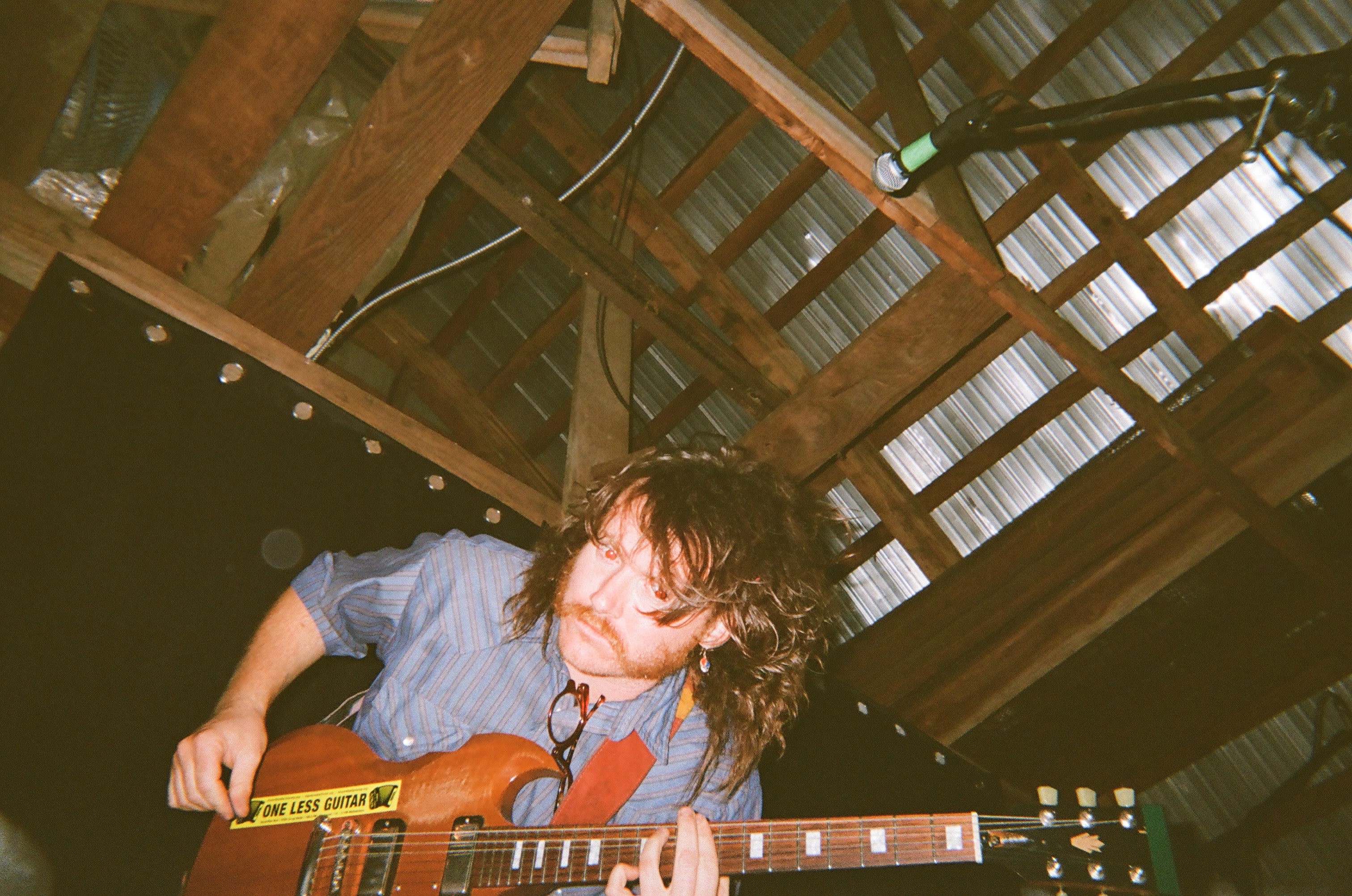 A guitar player playing a heavy riff on stage.